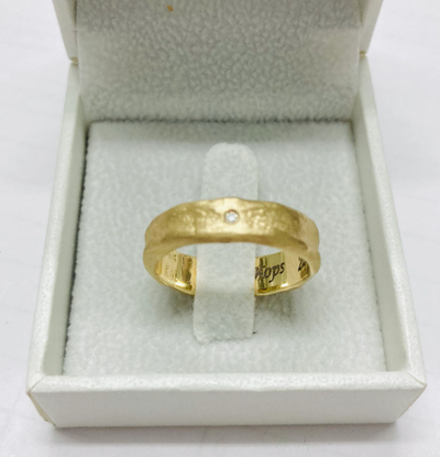 hand molded 5.5 mm wide gold band with diamond