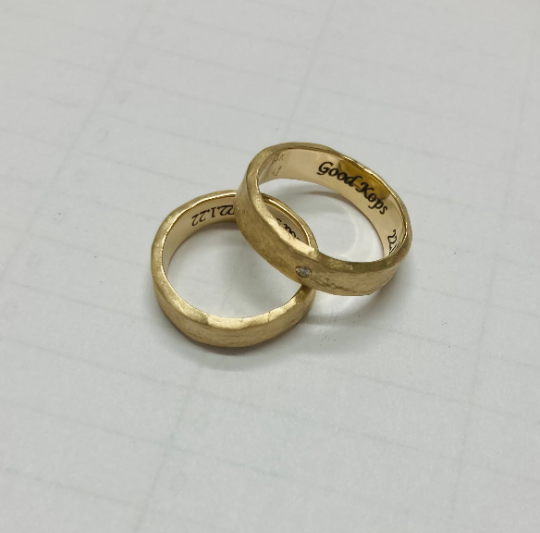 hand molded 5.5 mm wide gold band with diamond