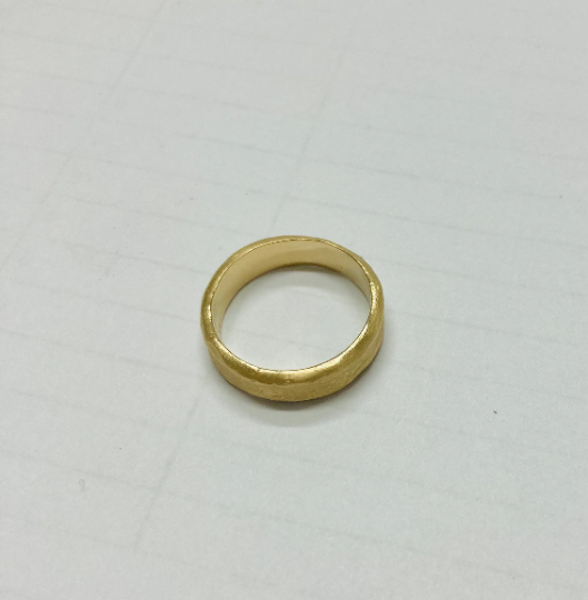 hand molded 5.5 mm wide gold band with diamond